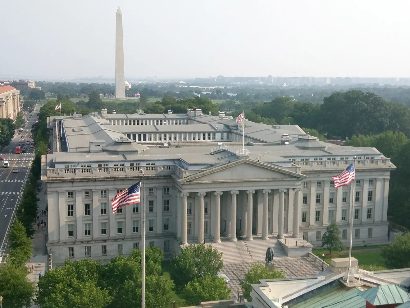 U.S. Treasury Building in Washington, D.C., with the Washington Monument behind it (Photo: MeanieHyaena / Wikimedia Commons, CC BY 4.0)
